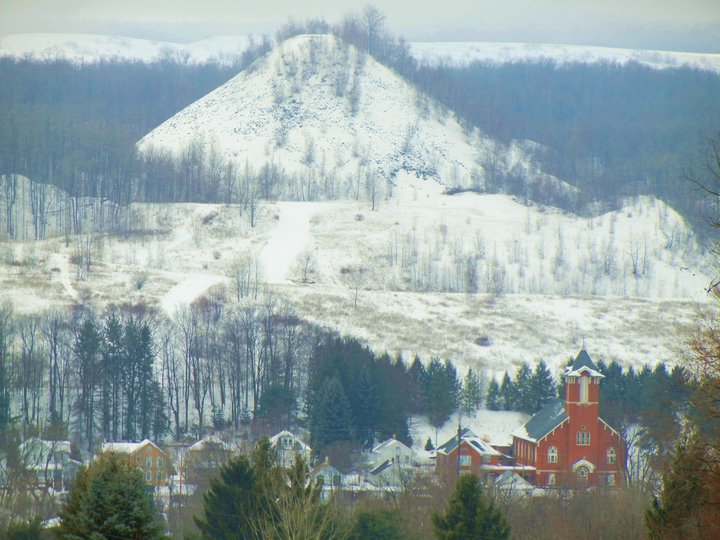 Simpson, Pennsylvania's "Mechanical Mountain," a relic of the coal mining the once dominated the region. I know it as somewhere we used to hike every summer growing up and the ever present backdrop to St. Mike's church, in the lower right hand corner. 